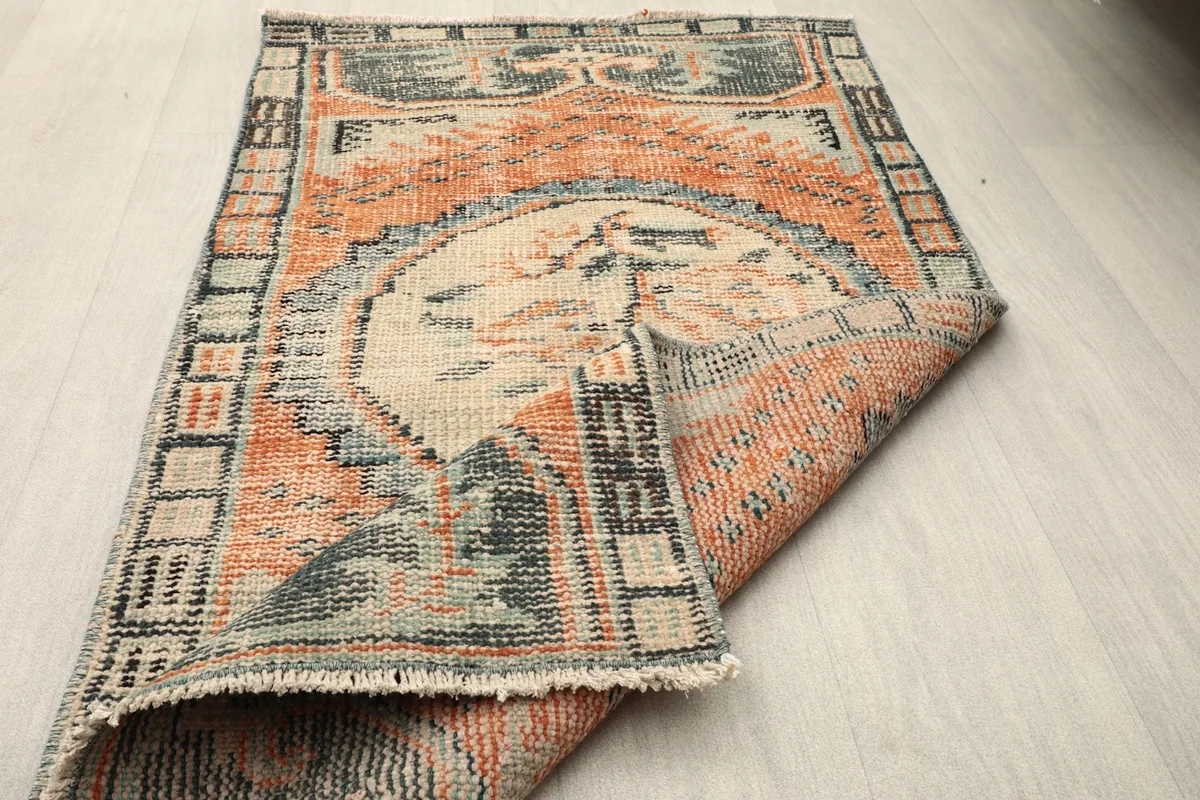 Rug partially folded, displaying the full design from an elevated perspective