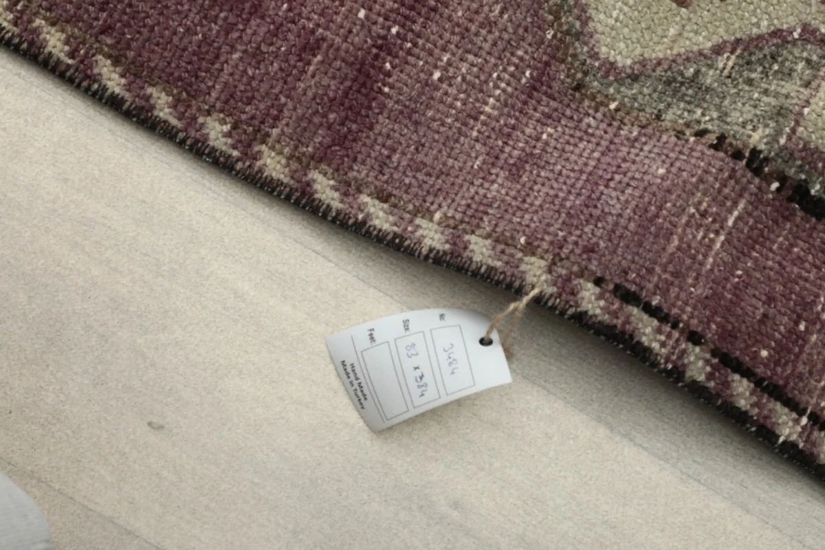 Close-up of the rug's edge with a product tag, indicating its origin and material