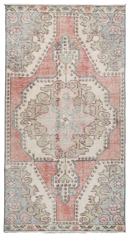 Top view of the 3x6 vintage Anatolian rug with a rose field, ivory medallion, and blue border.