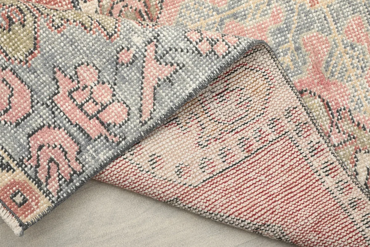 View of the rug's reverse side, showing the hand-knotted construction and wool on cotton foundation.