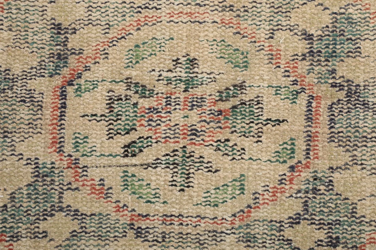 Macro view of the hand-knotted wool pile, showing individual knots and color variations