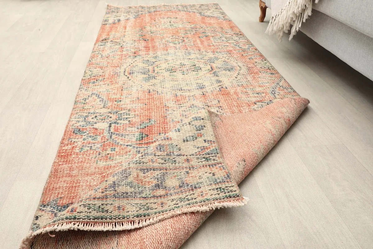 Rug partially rolled, showing the flexibility and thickness of the runner