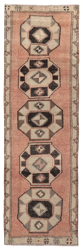 Full overhead view of the vintage rose, black, and beige geometric Anatolian runner rug