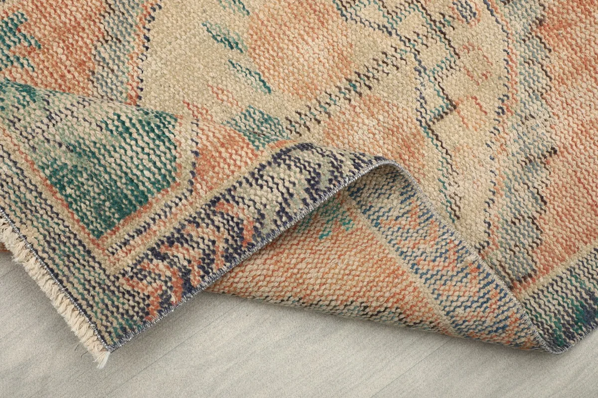Close-up of the back of the rug, revealing the tight hand-knotted cotton foundation