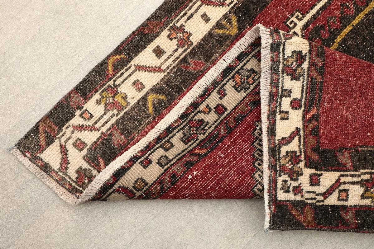 View of the runner folded to show the thickness of the wool pile and reverse side