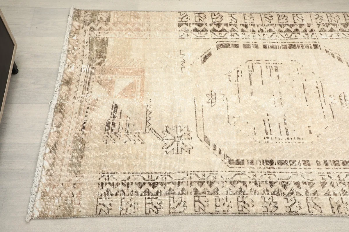 Detailed view of the rug's patterns and slight variations in color near the edge