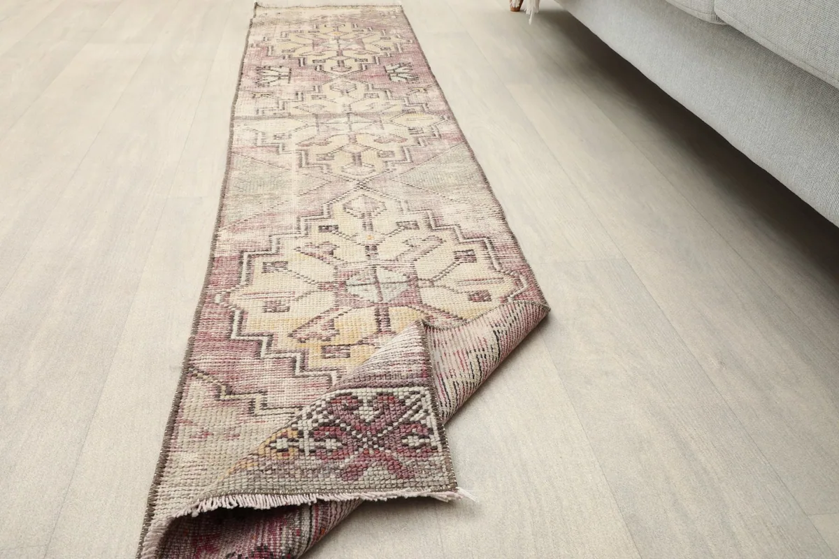 Runner rug partially folded, illustrating its flexibility and showing the overall design