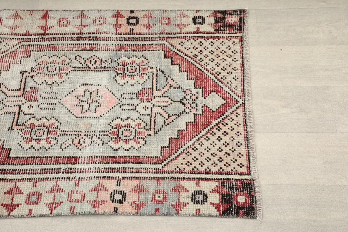 Close-up of the top right corner of the rug, highlighting the red and black border details.