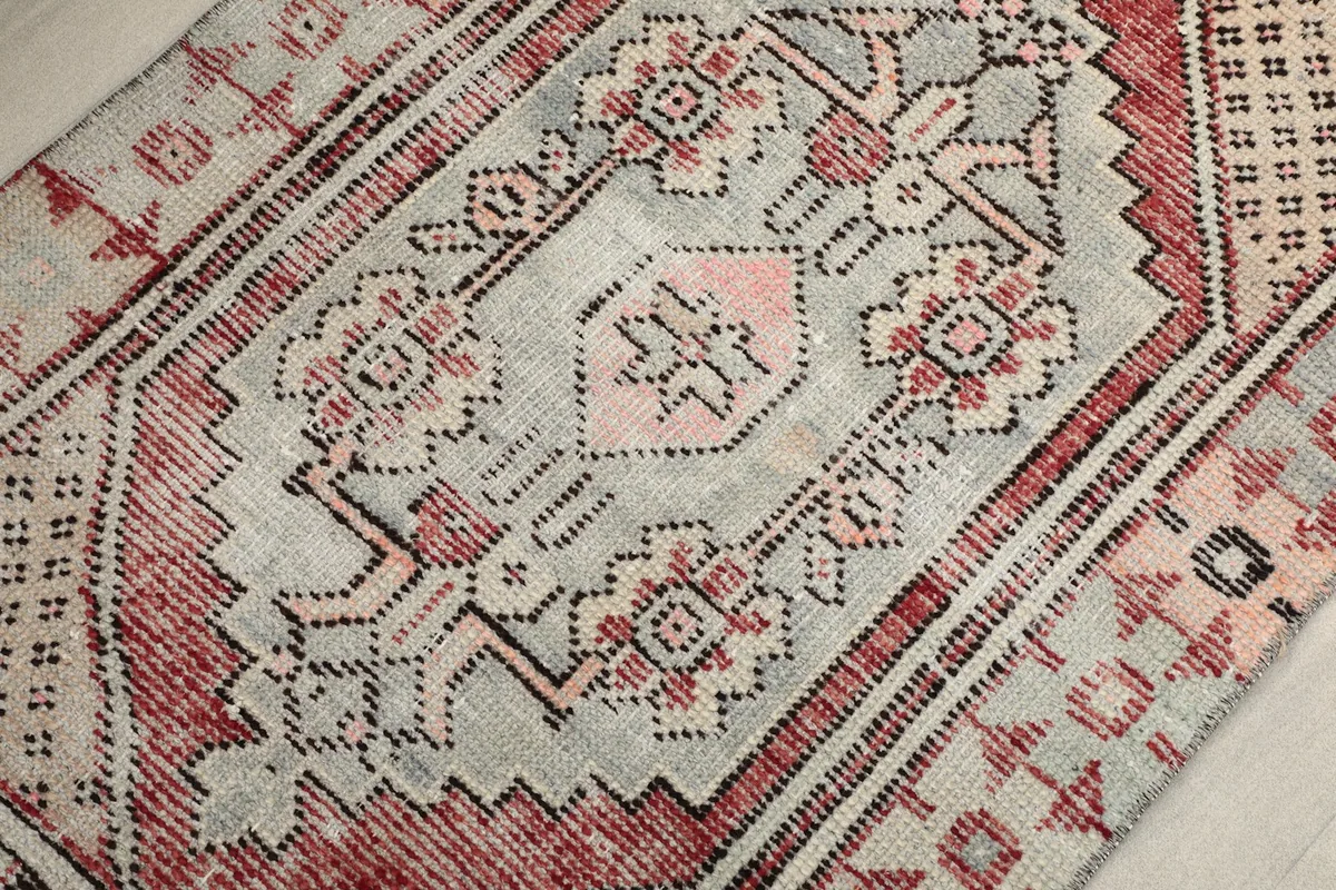 Detailed view of the central gray field and rose motifs with tribal patterns.