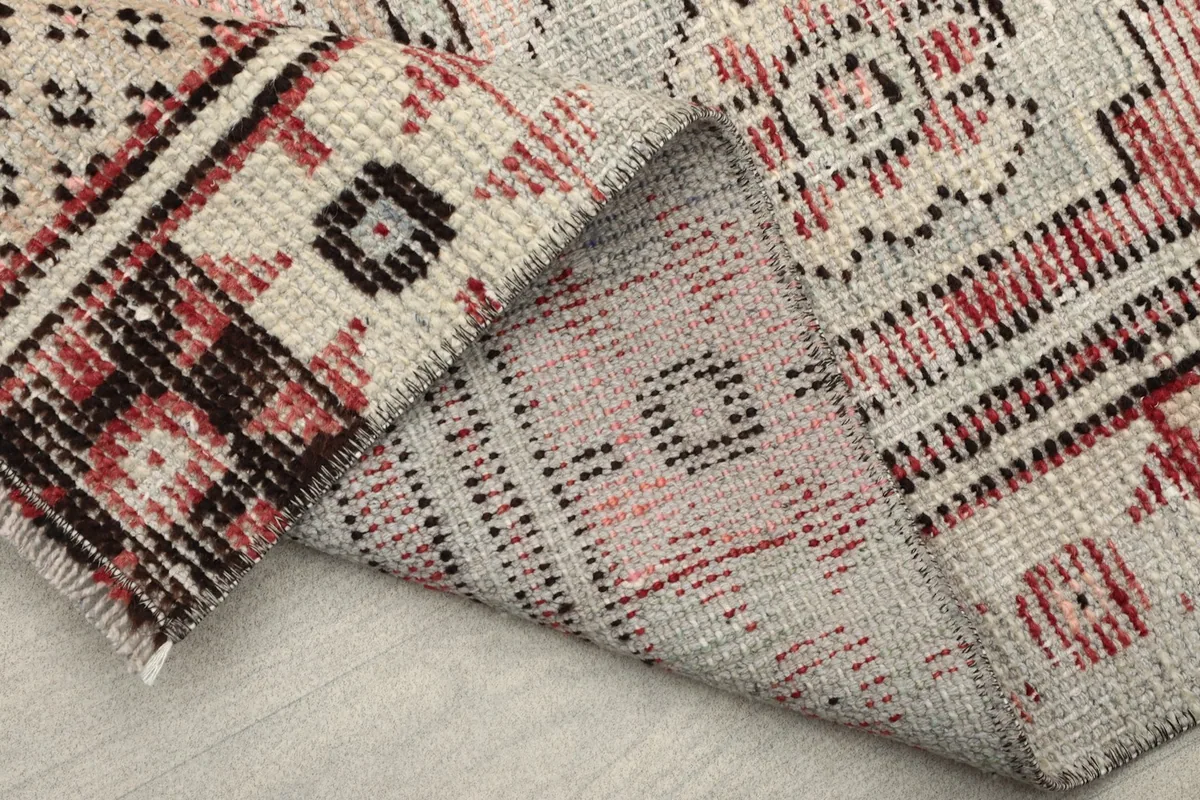 Close-up of the rug's backside, displaying the hand-knotted construction.