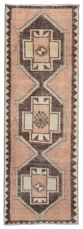 Full overhead view of the vintage rose and brown geometric Anatolian runner