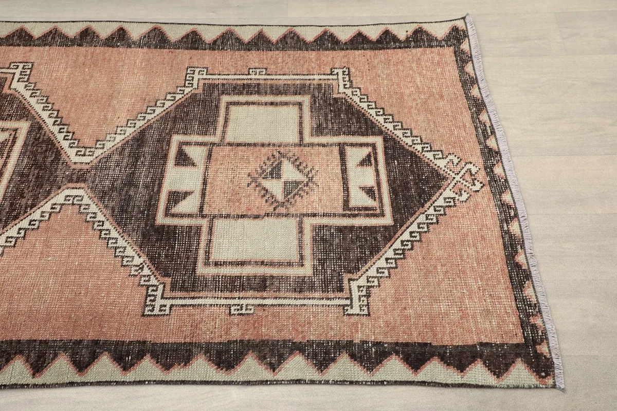 Close-up of a geometric medallion and border design on the runner