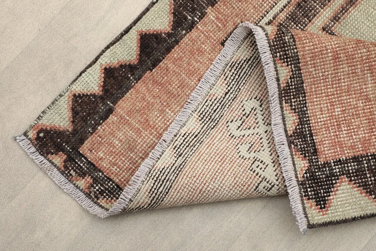 Folded corner of the runner showing the cotton foundation and reverse side