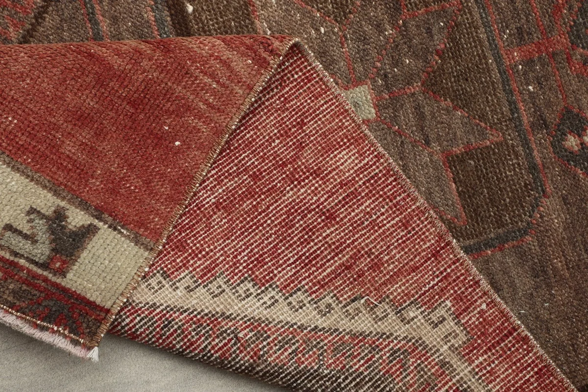 View of the rug's back, showing the hand-knotted cotton foundation and wool pile