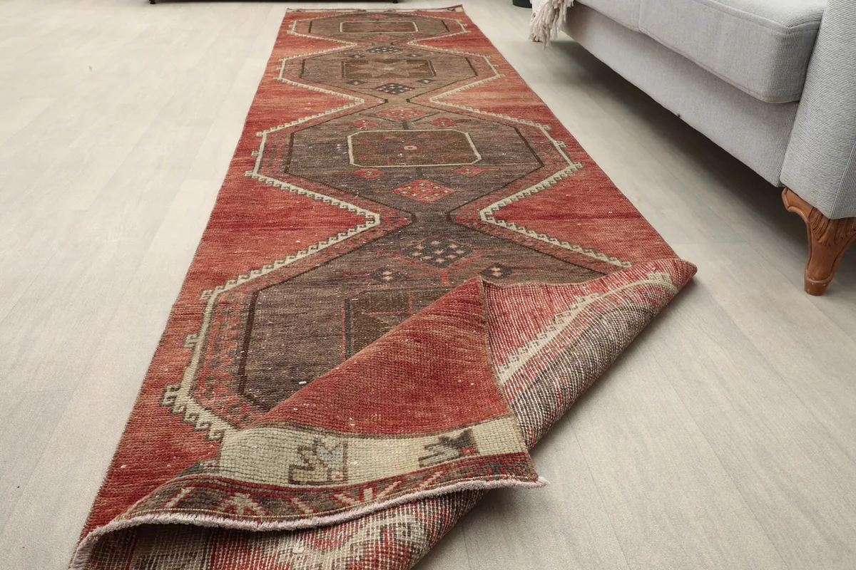 Overhead view of the runner rug partially rolled, showcasing its length and pattern