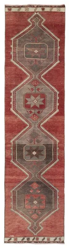 Full top view of the red and gray geometric Anatolian runner rug on a white background.