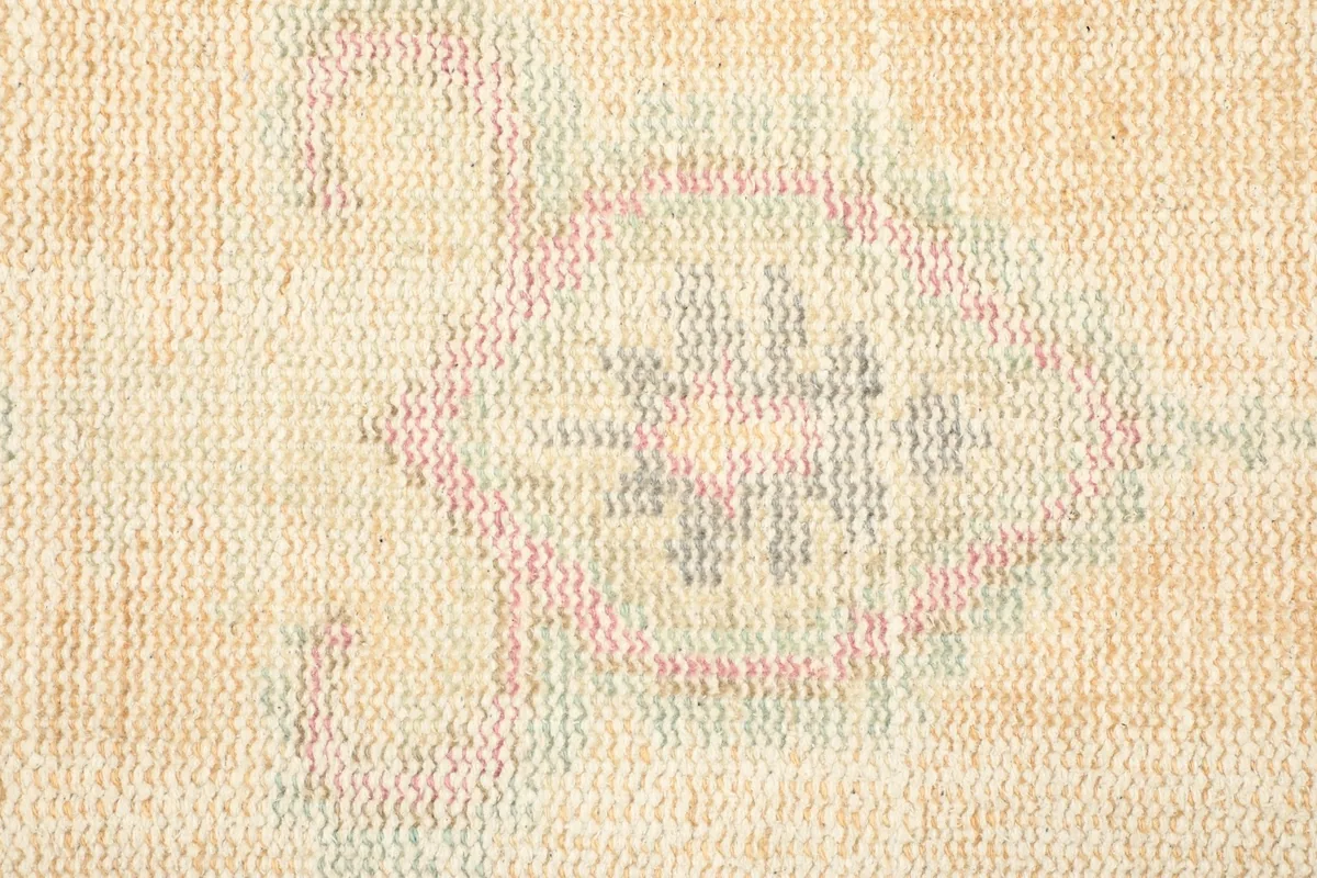 Detailed view of the low wool pile and the hand-knotted construction with subtle color variations