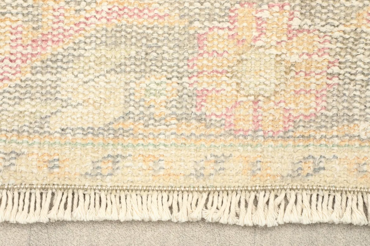 Close-up of the rug's fringe and a section of the border pattern