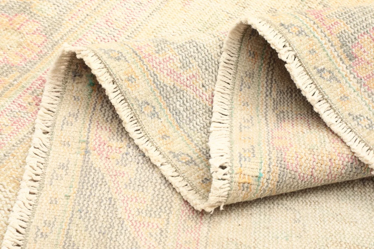 Folded section of the rug, illustrating the thickness and flexibility of the vintage wool material