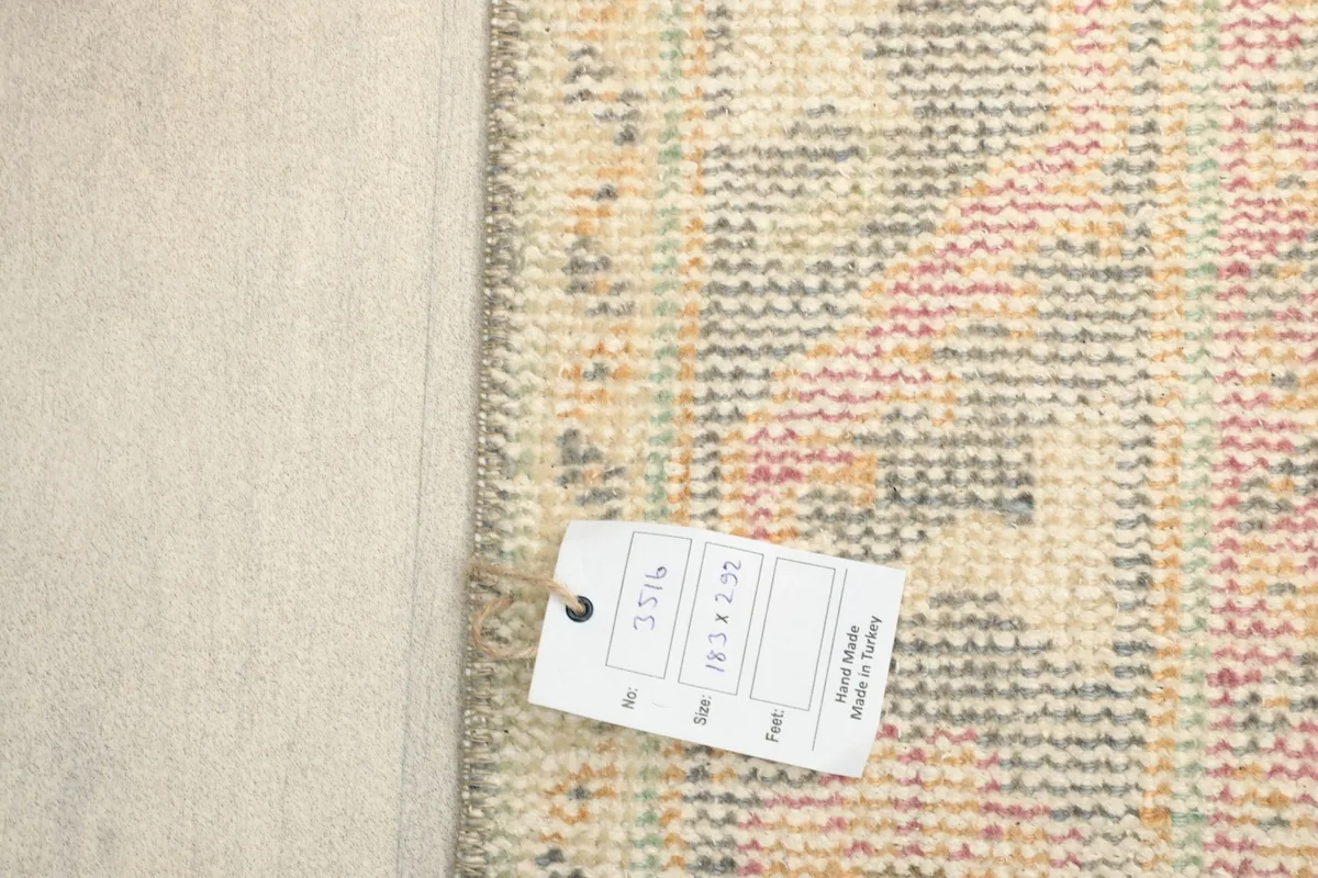 Close-up of the rug's back with a tag showing size and origin information