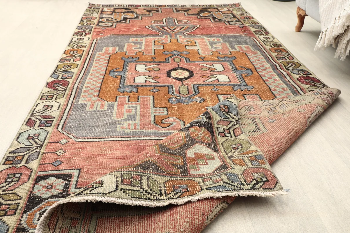 Rug partially folded, demonstrating its flexibility and the consistent design across the surface
