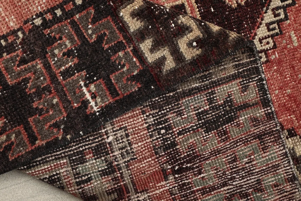 Detailed shot of the rug's reverse side, revealing the hand-knotted construction and foundation