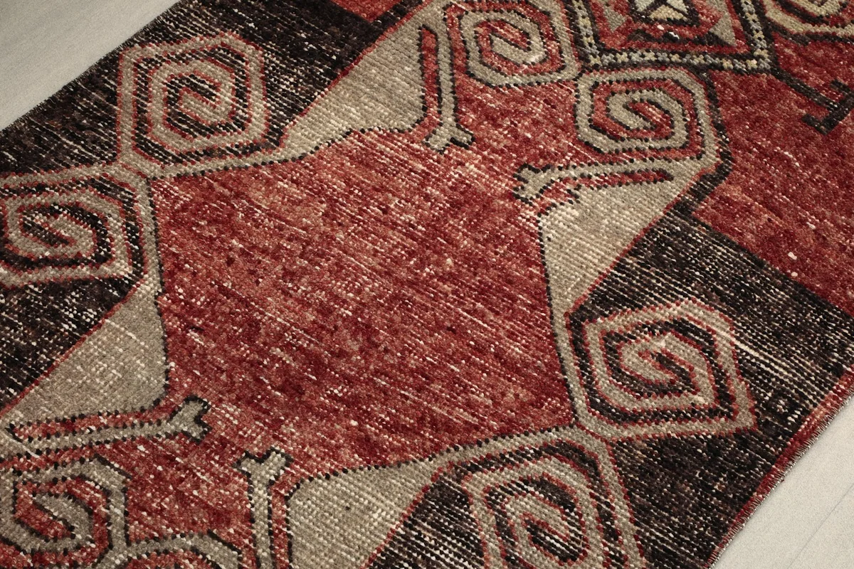 Detailed view of the low pile and texture, revealing the vintage wear and individual knotting