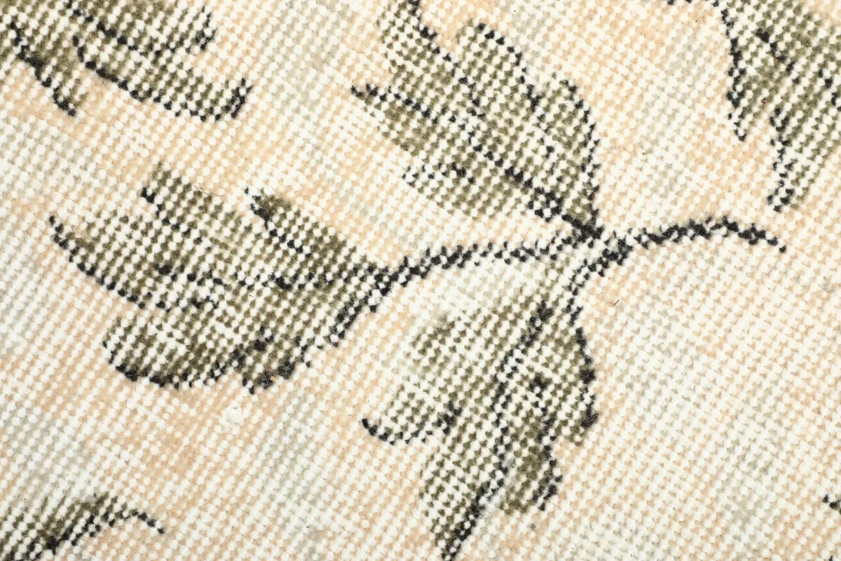 Detailed view of the low wool pile and hand-knotted texture of the rug