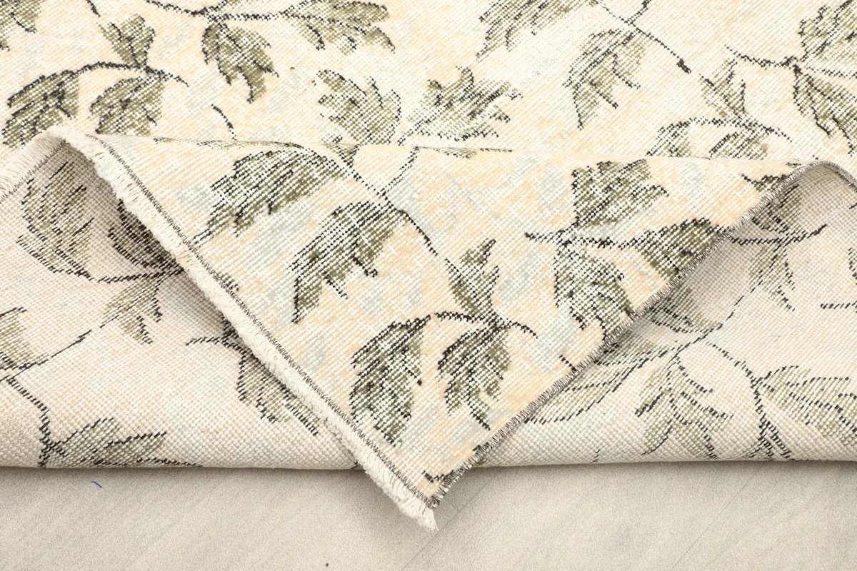 Folded corner showing the back of the rug, revealing the cotton foundation and knotting
