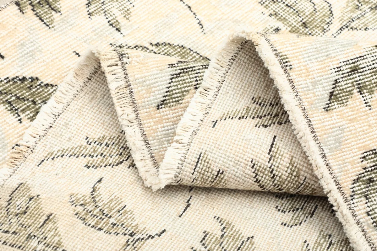 Multiple folds of the rug showing the flexibility and texture of the vintage wool material