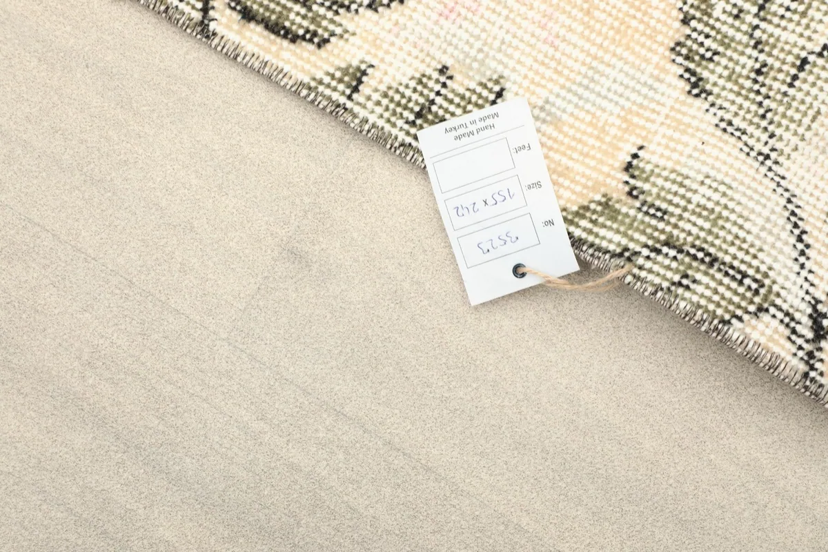 Close-up of the rug's corner with the product tag attached, showing details