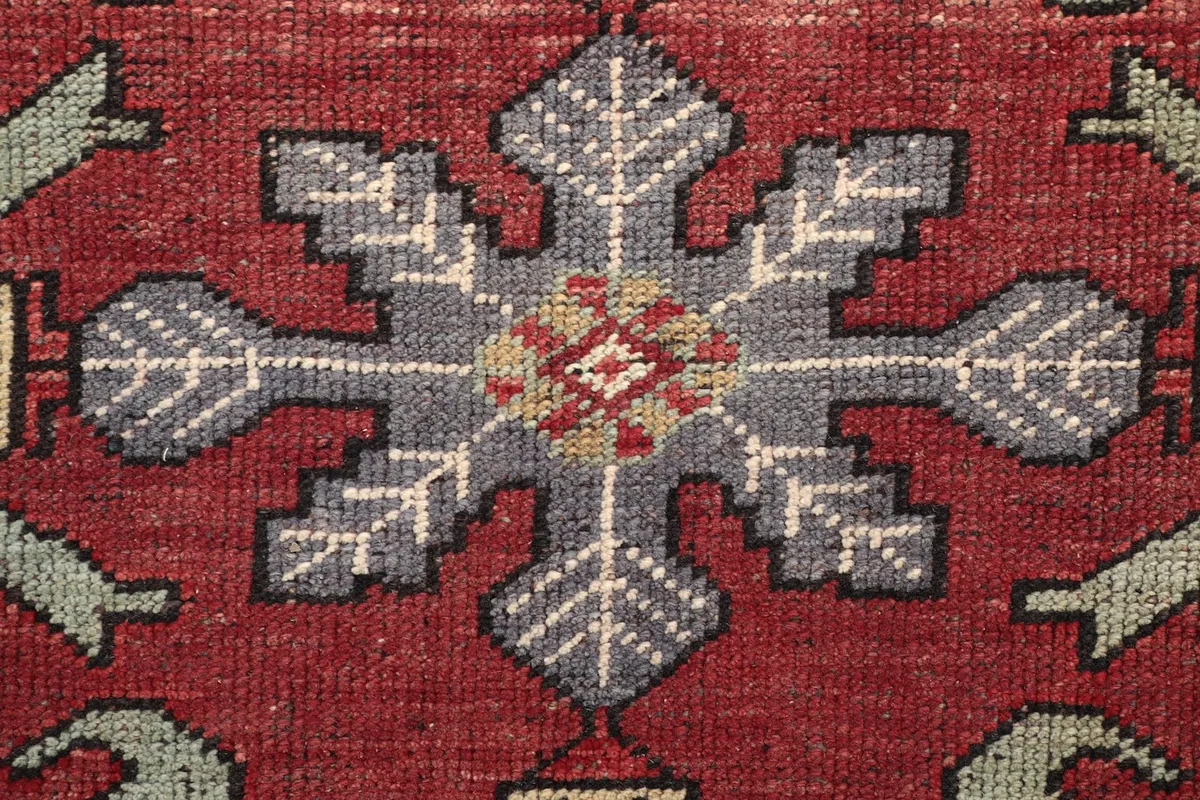 Extreme close-up of a specific motif within a medallion, showing the intricate hand-knotted wool texture.
