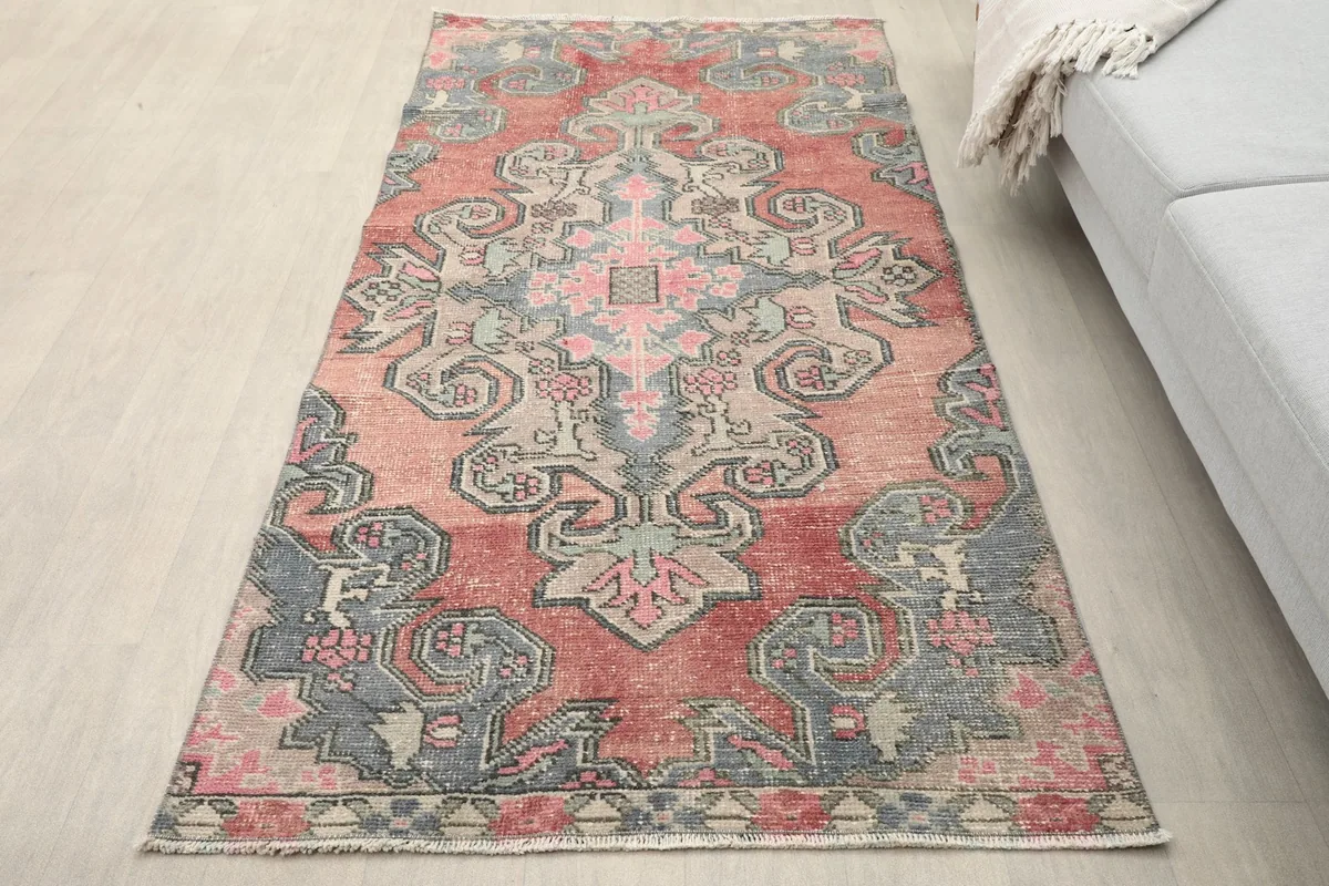 Overhead view of the rug placed in a room setting with a light gray sofa