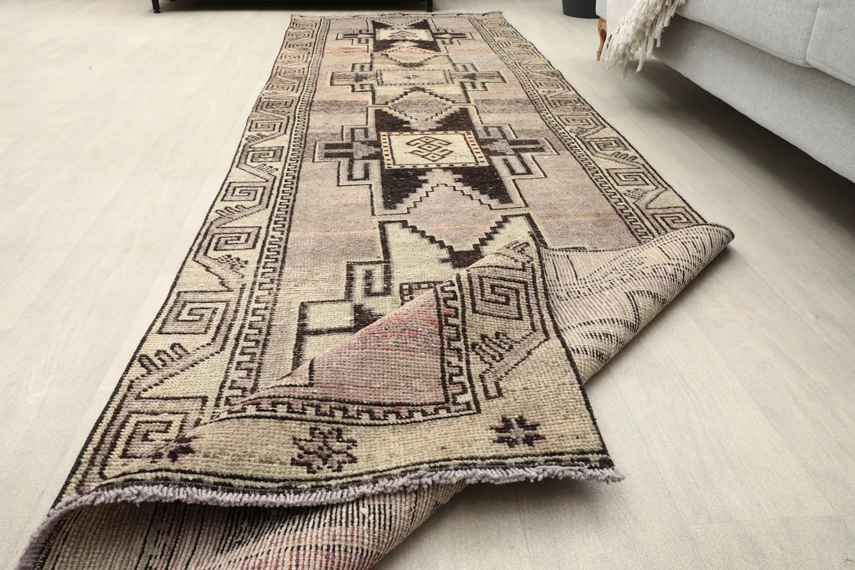 The runner partially unrolled on a light floor, illustrating its flexibility and full length.