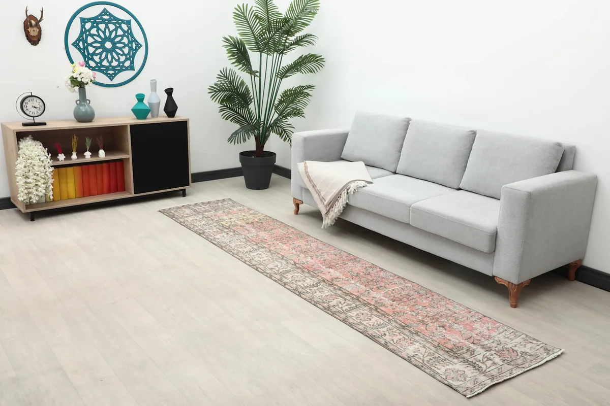 Wide shot of the runner rug in a living space with modern furniture and decor, showcasing its scale.