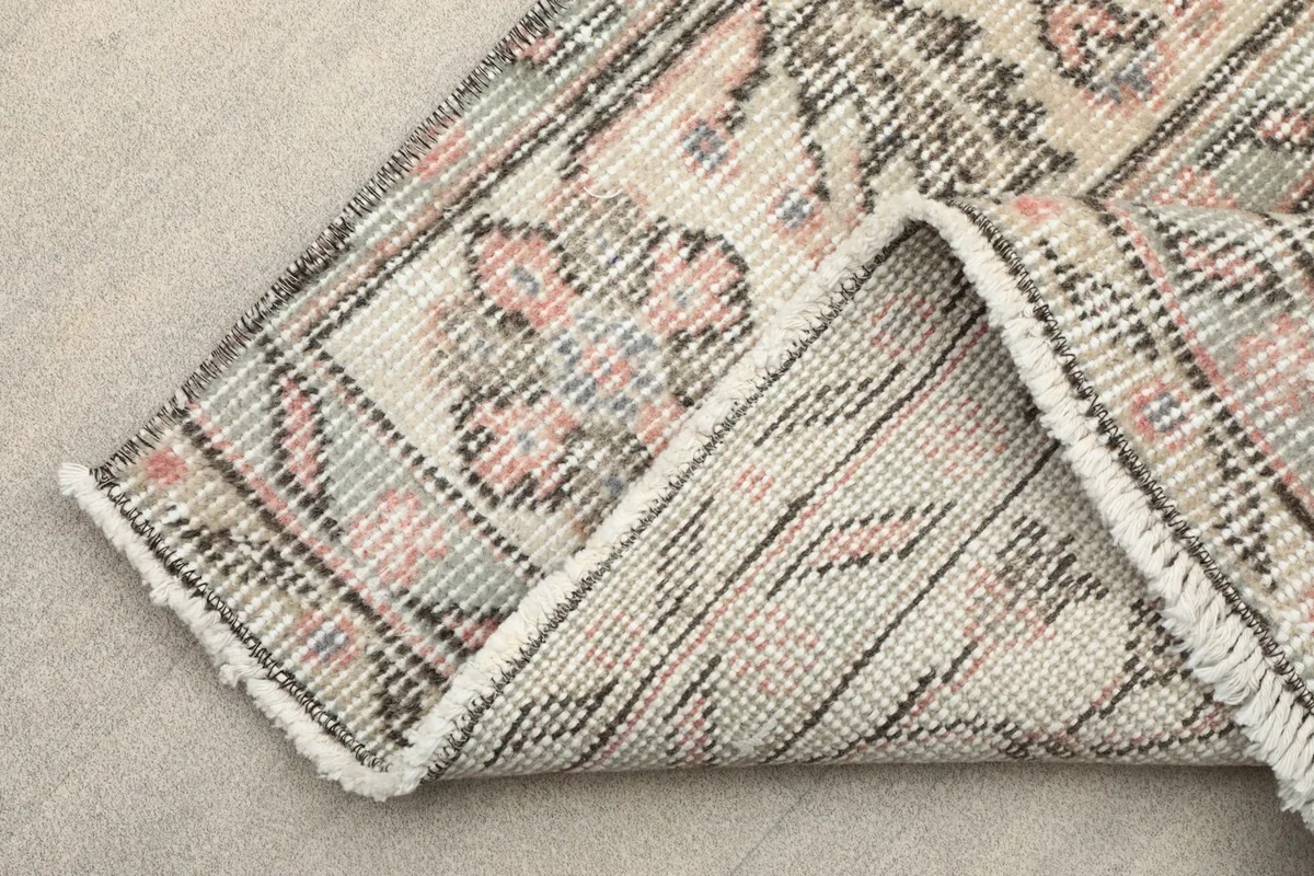 Another view of the rug's reverse, revealing the tight knotting and the structure of the vintage piece.