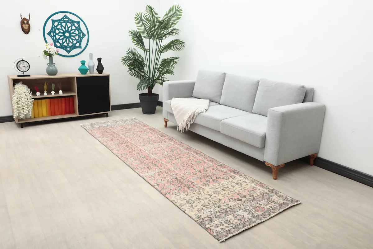 Runner rug placed in a living space, showcasing its scale next to a sofa and decor