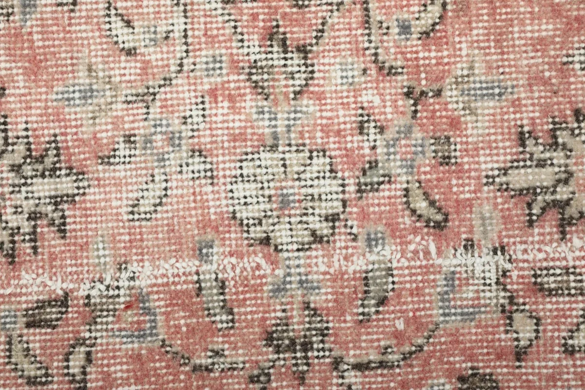 Extreme close-up of the low wool pile, revealing the hand-knotted texture and color variations