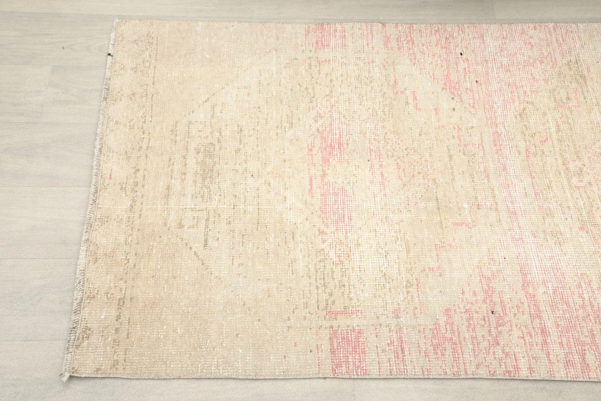 Detail view of one end of the runner, revealing faint geometric designs and color variation