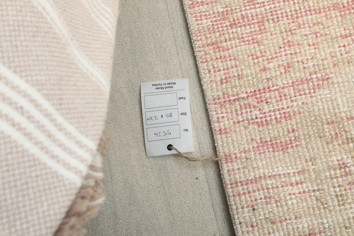 Tag attached to the rug's back, displaying product information and origin