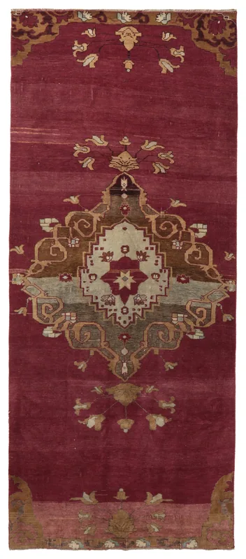 Full overhead view of the rose vintage Anatolian rug with a central geometric medallion.