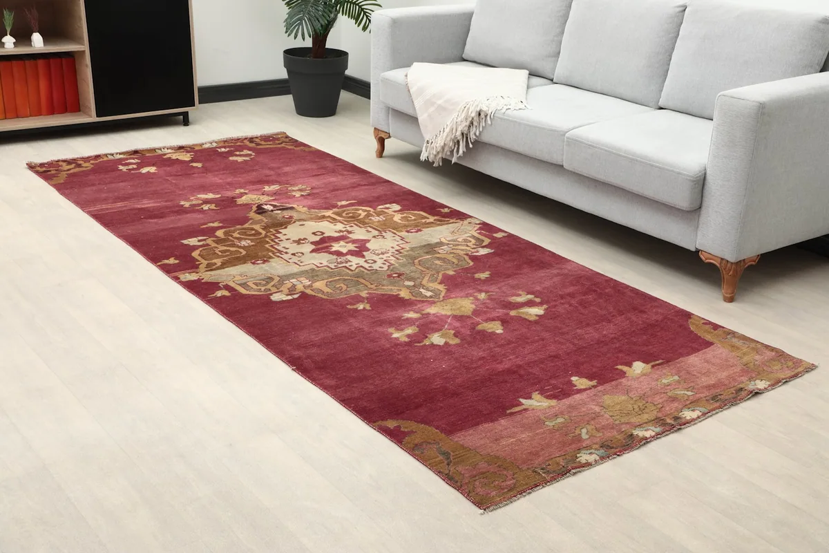 Close-up room view of the rose rug, highlighting its placement next to a sofa.