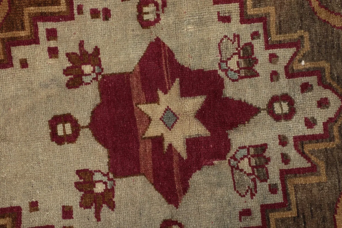 Macro detail of the medallion's star-like center and surrounding patterns.