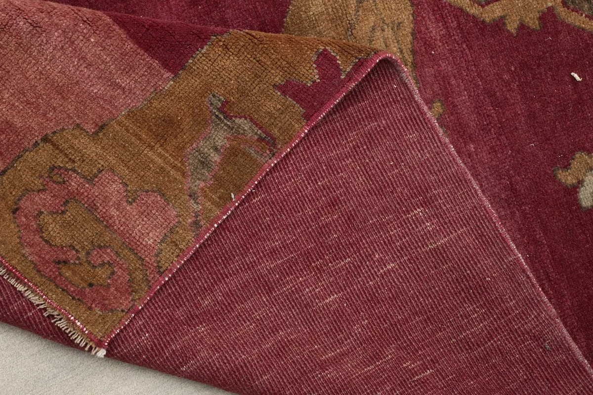 Underside view of the hand-knotted cotton foundation on the rose area rug.