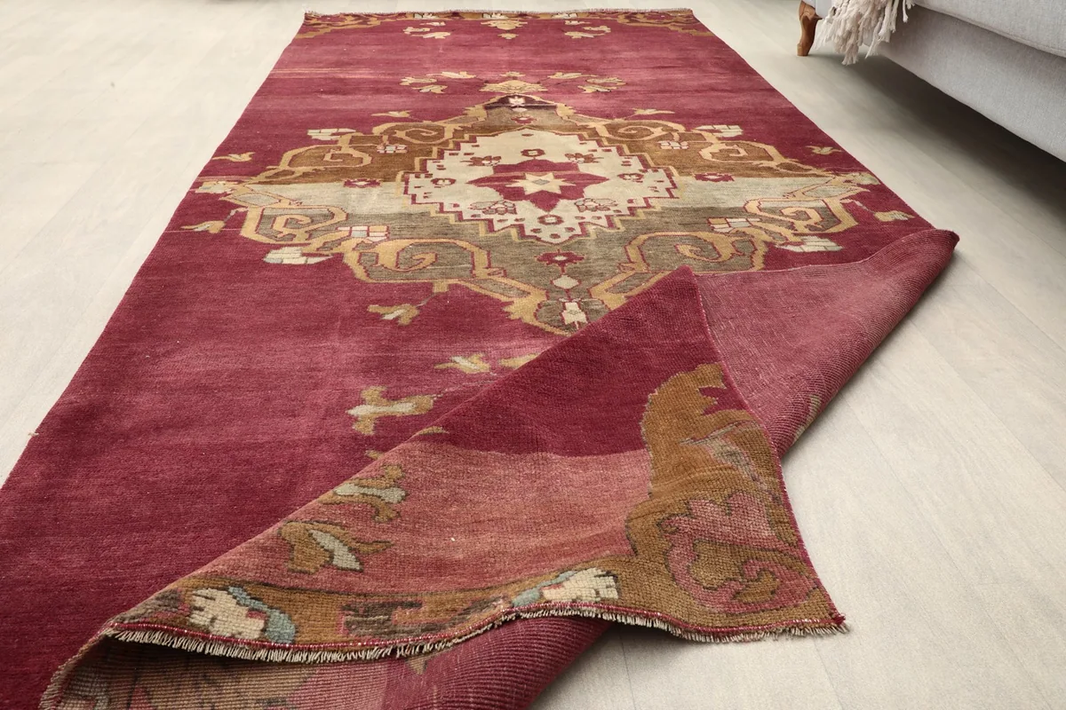Partial fold of the rose rug, showing the texture and construction.