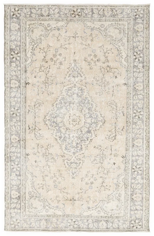 Full top view of the beige and gray medallion Anatolian rug on a white background