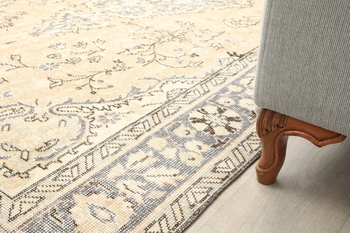 Rug edge next to a furniture leg, demonstrating its placement in a room