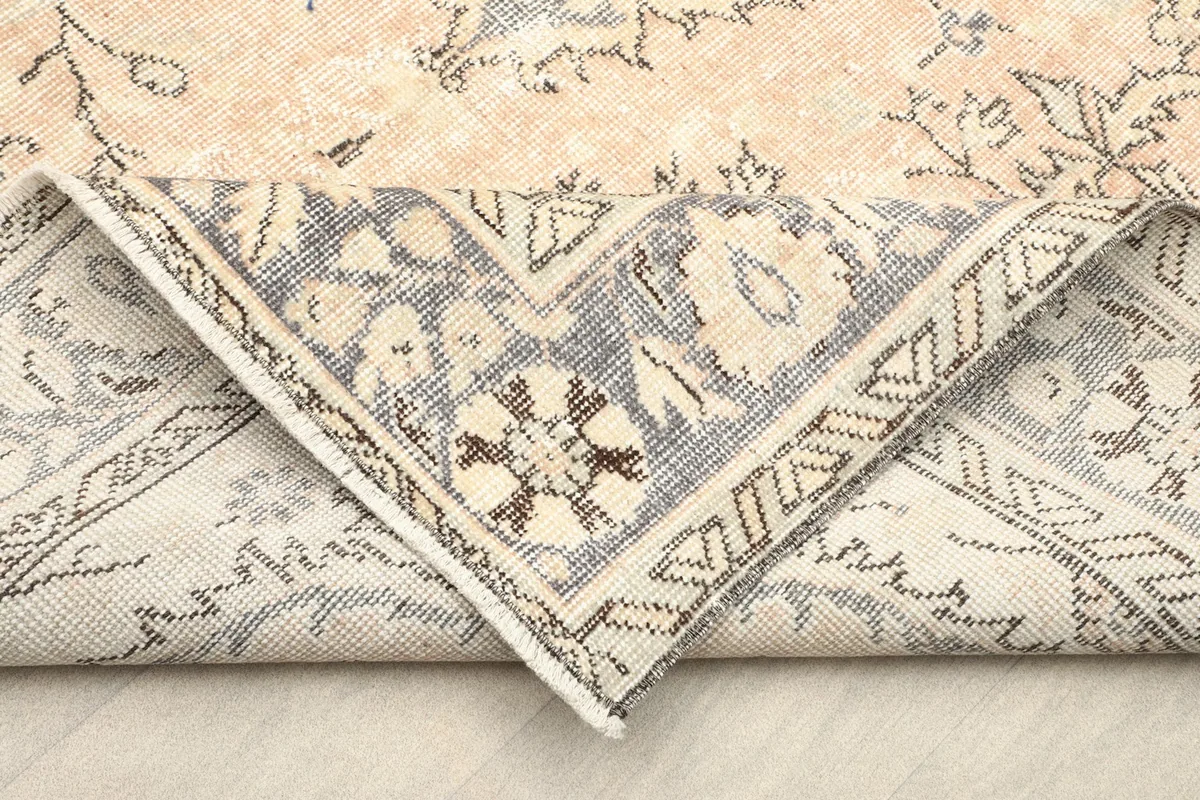 Folded corner showing the reverse side of the hand-knotted wool rug