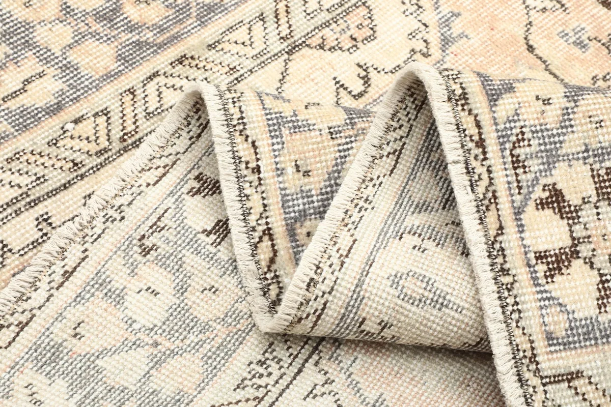 Folded section of the rug, illustrating the texture and flexibility of the wool pile