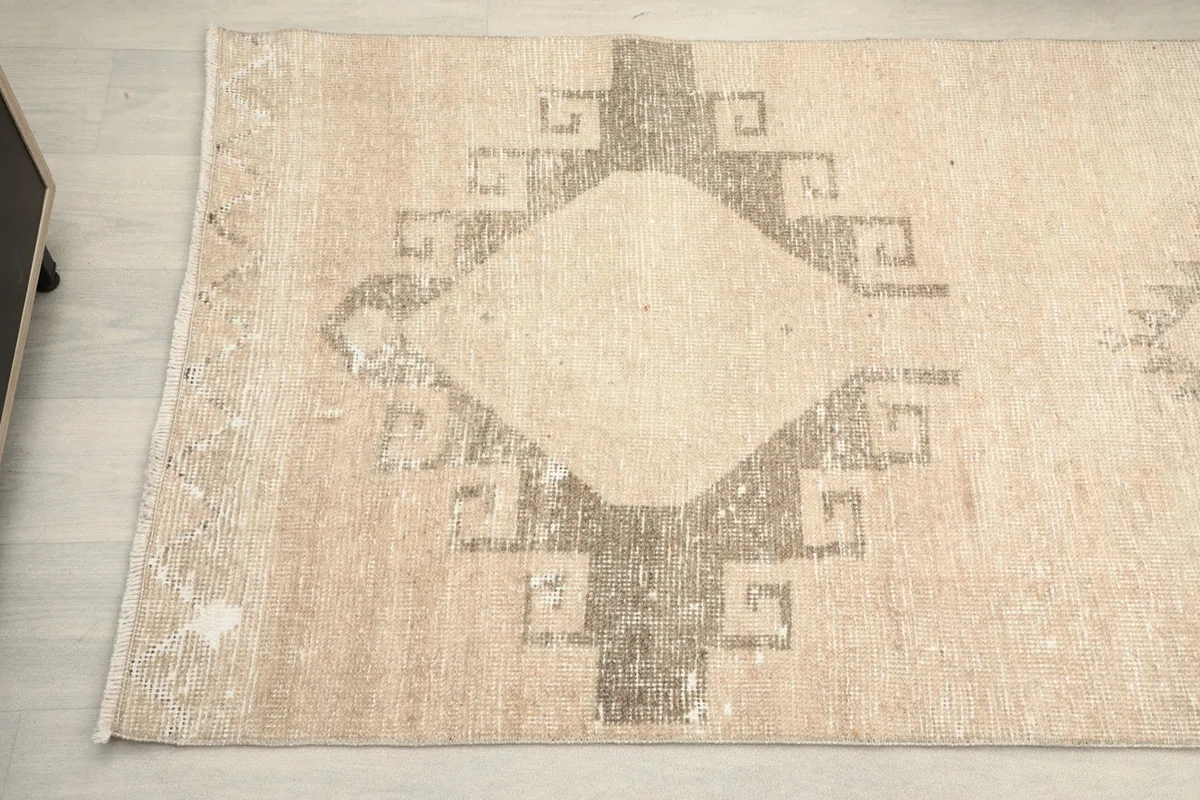 Detailed view of the runner's surface, highlighting the faded gray pattern and natural wear.